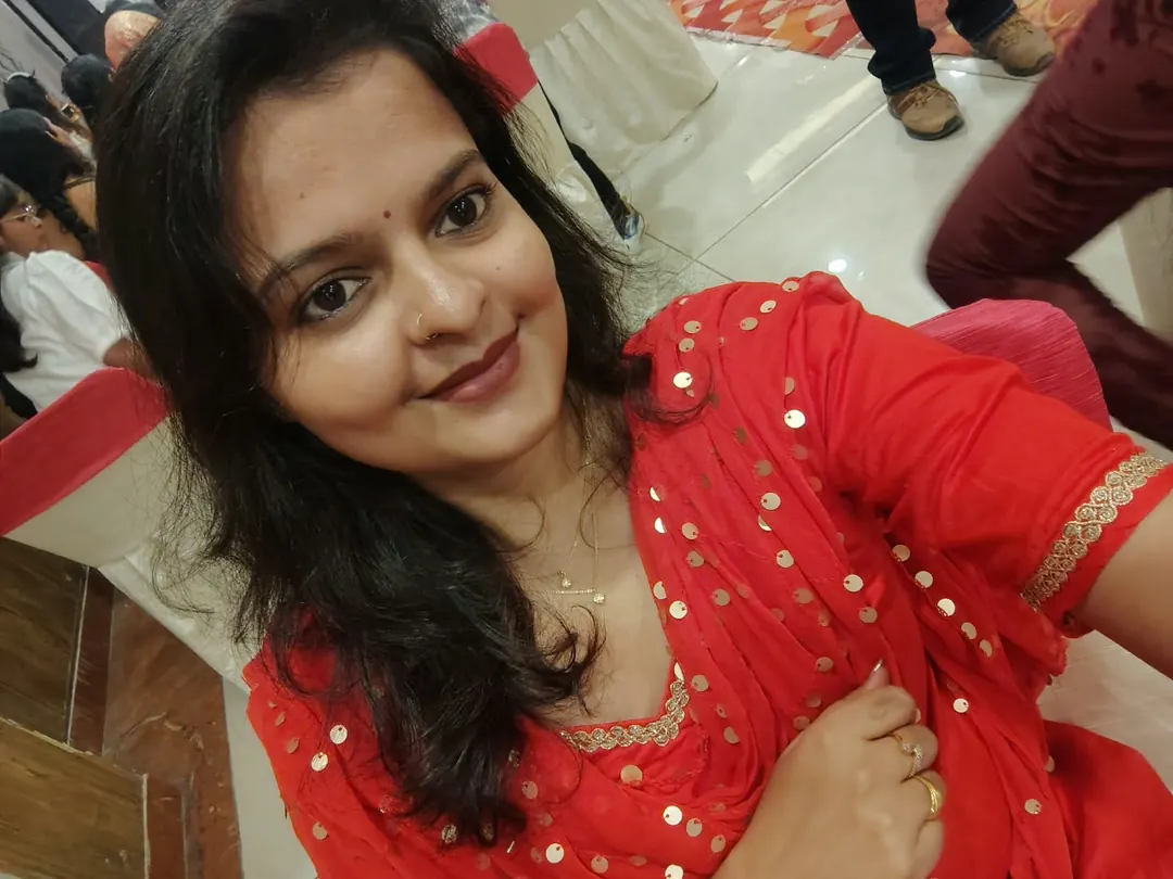 Udita in a red and gold festive outfit.
